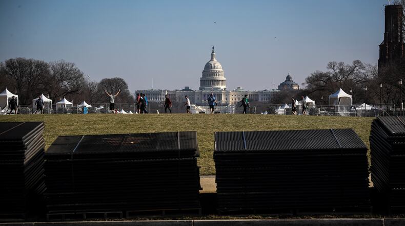 Temporary security fencing is stacked on the National Mall near the Capitol in Washington on Tuesday, Jan. 12, 2021, in advance of Inauguration Day. Security experts have warned that some far-right extremist groups have now started to focus attention on Inauguration Day and are already discussing an assault similar to the one on the Capitol last week. (Oliver Contreras/The New York Times)