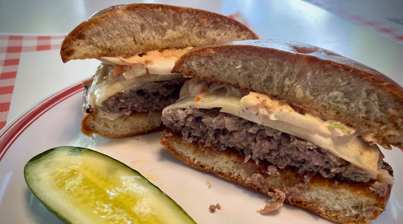 All The Best Delicatessen is now offering the Bestie Burger, a 6 oz. all beef burger topped with Swiss cheese, coleslaw and Russian dressing on a grilled challah knot. NATALIE JONES/STAFF