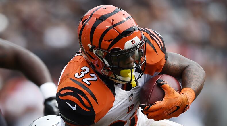 OAKLAND, CA - SEPTEMBER 13: Jeremy Hill #32 of the Cincinnati Bengals is hit by Nate Allen #20 of the Oakland Raiders during the first half of their NFL game at O.co Coliseum on September 13, 2015 in Oakland, California. (Photo by Thearon W. Henderson/Getty Images)
