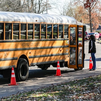 Staff members wait for children to be dismissed from Oakview Elementary School in a bus pickup lane on Monday, Nov. 17, in Kettering. BRYANT BILLING/STAFF