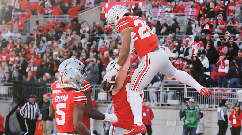 Ohio State running back James Peoples, top, celebrates with teammates after scoring a touchdown against Rutgers during the second half of an NCAA college football game, Saturday, Nov. 22, 2025, in Columbus, Ohio. (AP Photo/Jay LaPrete)