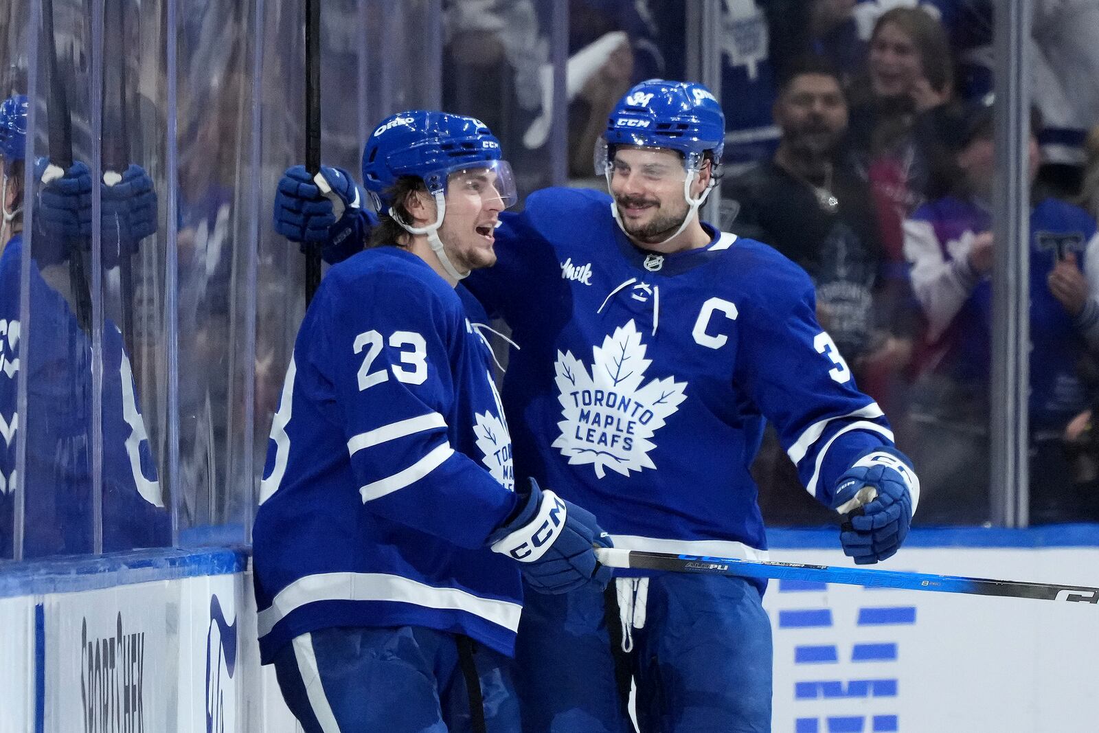 Toronto Maple Leafs forward Matthew Knies (23) celebrates after his goal with teammate Auston Matthews (34) during the third period of Game 1 in an NHL hockey second-round playoff series against the Florida Panthers in Toronto, Monday, May 5, 2025. (Nathan Denette/The Canadian Press via AP)