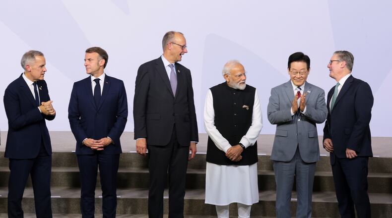 From left, Canada's Prime Minister Mark Carney, France's President Emmanuel Macron, Germany's Chancellor Friedrich Merz, India's Prime Minister Narendra Modi, South Korea's President Lee Jae Myung, and British Prime Minister Keir Starmer stand as leaders pose for a group photo, on the opening day of the G20 Leaders' Summit, in Johannesburg, South Africa, Saturday, Nov. 22, 2025. (Yves Herman/Pool Photo via AP)
