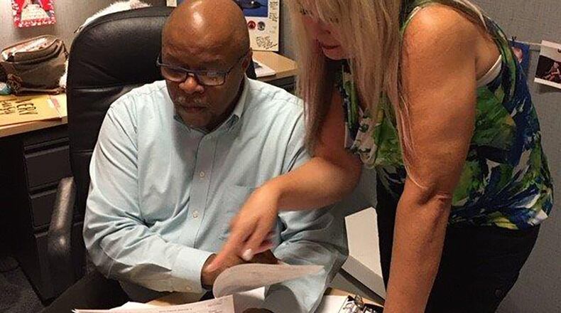 Wilburn Slack, 88th Comptroller Squadron Civil Engineering budget analyst, and Shannon Noles, 88th Comptroller Squadron supervisory accountant, demonstrate how they discuss and execute fiscal year close-out information. (U.S. Air Force photo/Kimberly Gaither)