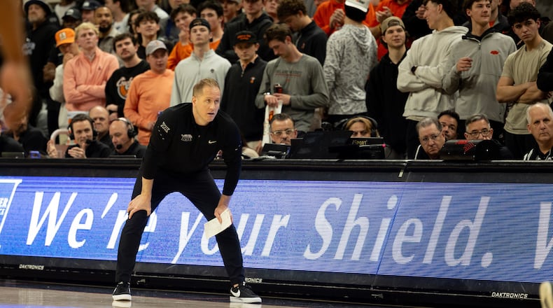BYU head coach Kevin Young stands on the baseline in the first half of an NCAA college basketball game against Oklahoma State, Wednesday, Feb. 4, 2026 in Stillwater, Okla. (AP Photo/Mitch Alcala)