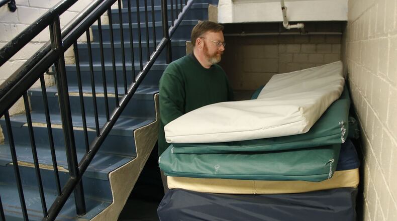 The forecast of sub-zero temperatures prompted local shelters and cities to open warming centers for residents, including the homeless. “We’re here 24/7, we have plenty of physical space and we never turn anyone away,” says St. Vincent de Paul executive director Michael Vanderburgh, seen here in the shelter stacking extra mattresses. TY GREENLEES / STAFF