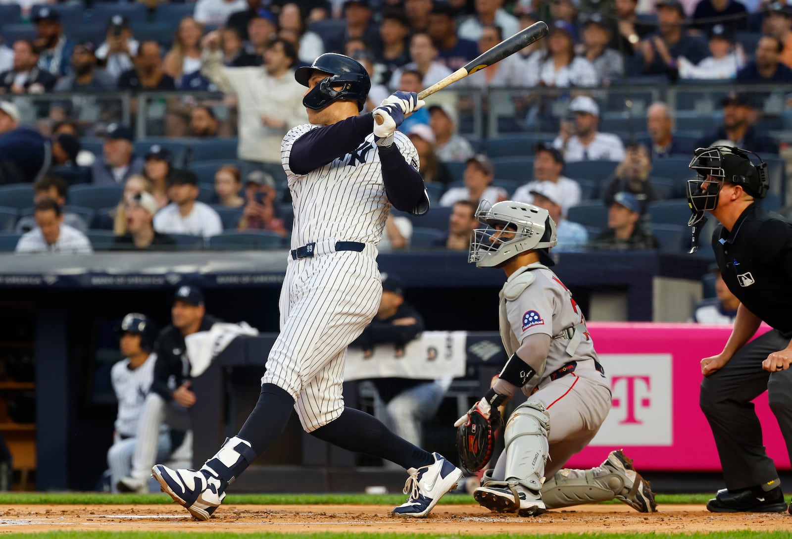 New York Yankees outfielder Aaron Judge (99) follows through on a two run home run against the Boston Red Sox during the first inning of a baseball game, Sunday, June 8, 2025, in New York. (AP Photo/Noah K. Murray)
