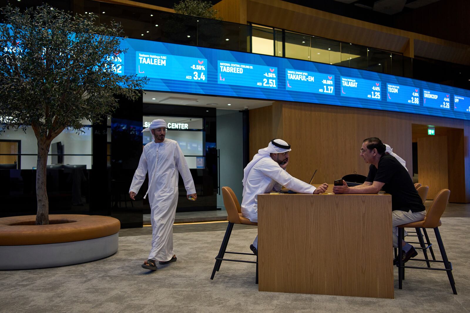 Emiratis are seen in the Dubai Financial Market in Dubai, United Arab Emirates, Monday, April 7, 2025. (AP Photos/Fatima Shbair)