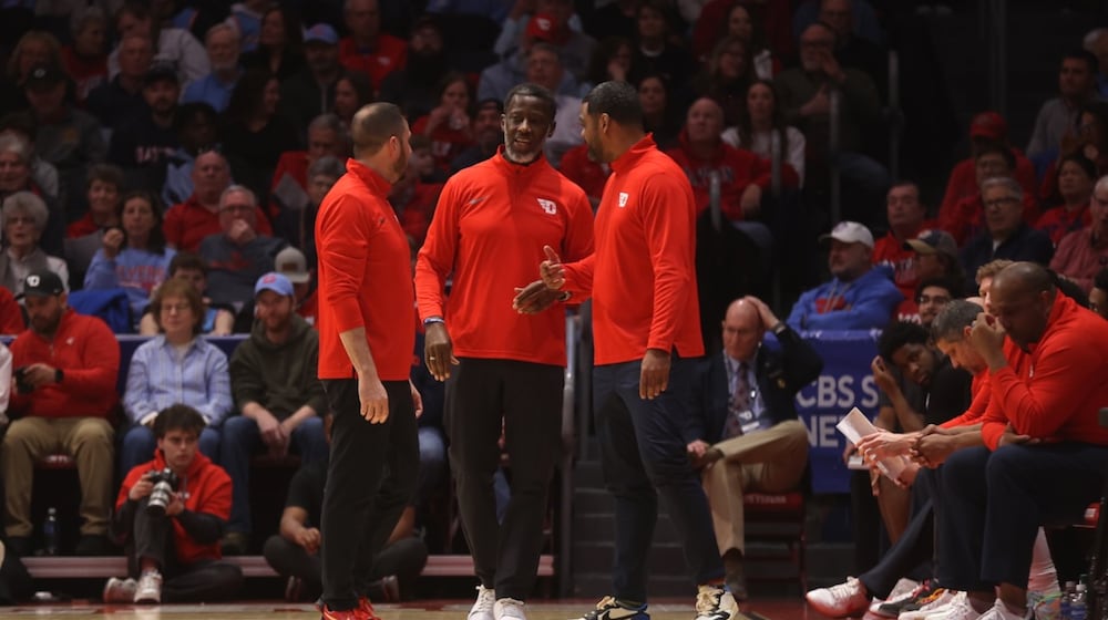 Dayton's James Kane, left, Anthony Grant, center, and Ricardo Greer huddle during a game against St. Bonaventure on Tuesday, Feb. 3, 2026, at UD Arena. David Jablonski/Staff