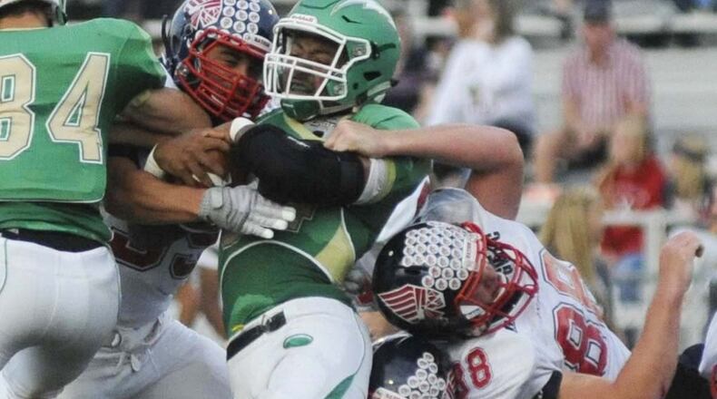 Northmont running back Devin Kenerly (with ball) draws several Piqua defenders, including Nathan Mommub (88). Northmont hosted Piqua in a Week 4 GWOC high school football crossover game on Friday, Sept. 18, 2015. MARC PENDLETON / STAFF