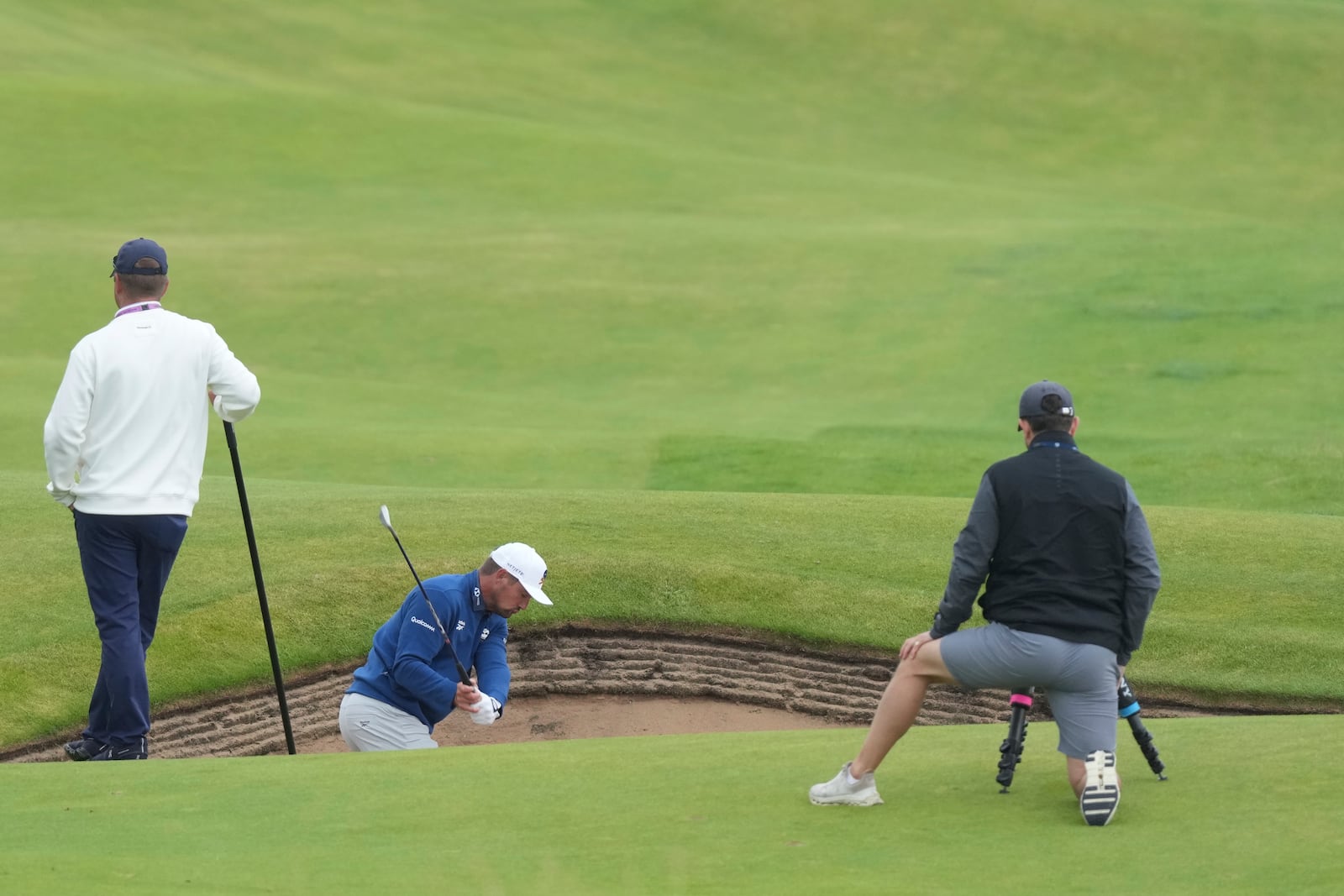 Bryson DeChambeau of the United States plays out of a bunker on the 9th hole during a practice round for the British Open golf championship at the Royal Portrush Golf Club, Northern Ireland, Tuesday, July 15, 2025. (AP Photo/Jon Super)