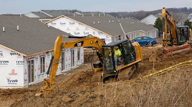 Construction workers complete new apartments at Fairfield Oakes in Fairborn in 2012. TY GREENLEES / FILE