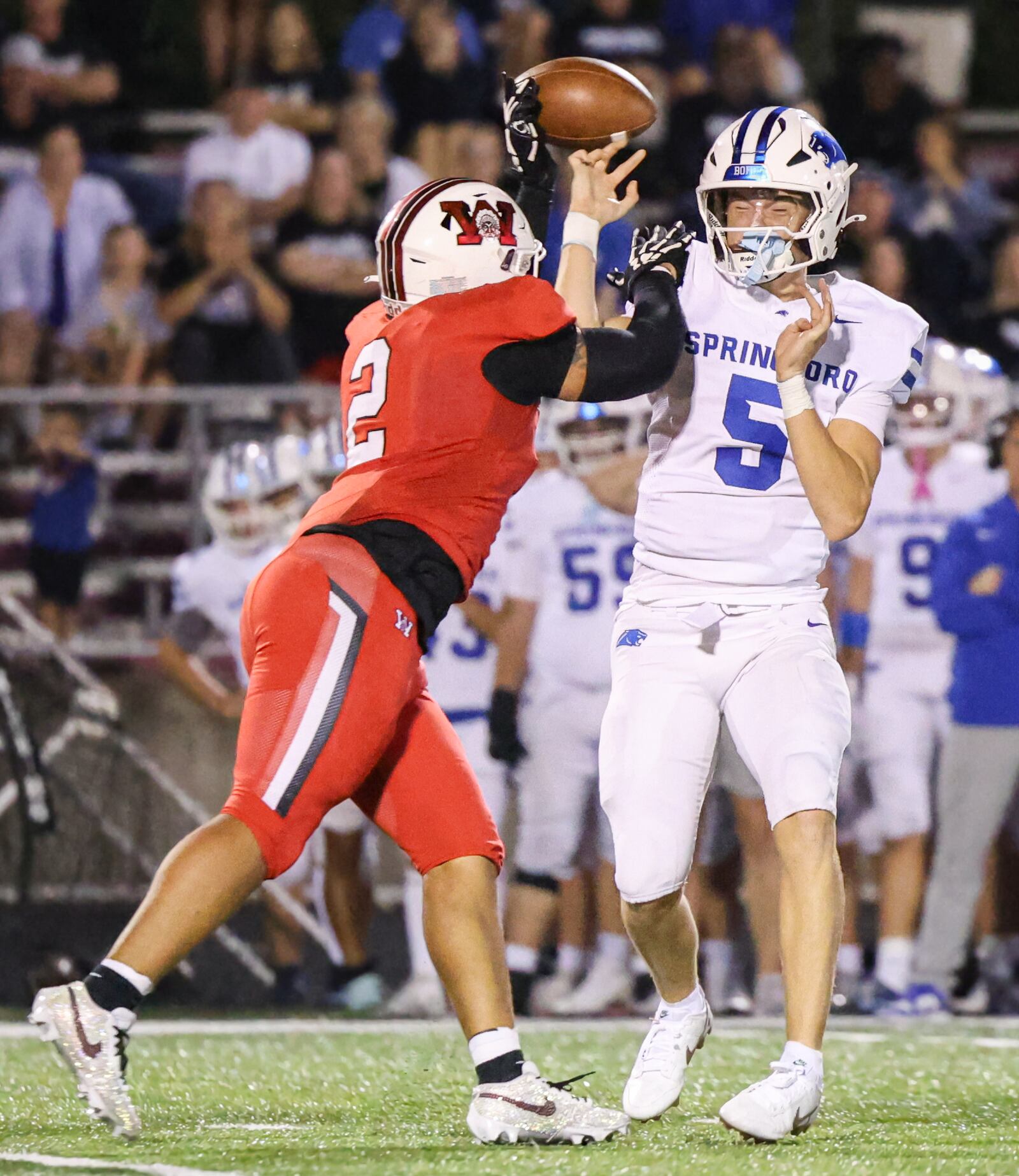 Wayne senior running back Isaiah Thompson deflects a pass as Springboro's Max Miller tries to throw during a Greater Western Ohio Conference game on Friday, Sept. 12 at Heidkamp Stadium. BRYANT BILLING / STAFF