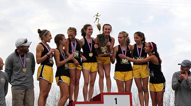 The Centerville Elks celebrate a fourth straight Division I cross country state championship at National Trail Raceway on Saturday. Contributed / Greg Billing