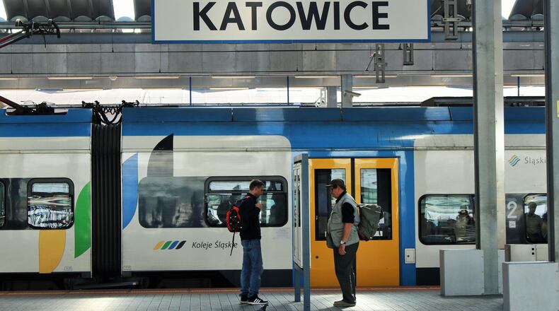 Two men and a pigeon examine timetables at the station in Katowice connection point for the train to Wroclaw. (Alan Solomon/Chicago Tribune/TNS)