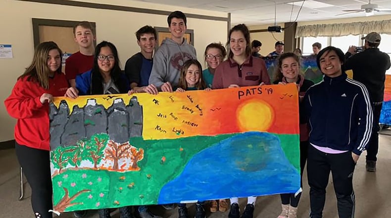 Carroll High School seniors display a hand-painted banner they made during PATS (Praying and Thinking Spiritually) Retreat in February 2019 at Camp Kirkwood in Wilmington. Each year, approximately 150 Carroll seniors participate in this voluntary retreat led by their classmates. Contributed photo