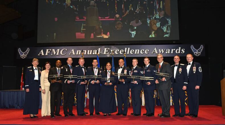 Gen. Ellen Pawlikowski (from left), commander, Air Force Materiel Command; Patricia Young, AFMC executive director; Maj. Gen. Warren Berry, AFMC vice commander; and Chief Master Sgt. Jason France, AFMC command chief, pose for a group photo with the winners of their respective categories during the AFMC annual Excellence Awards Banquet March 7 inside the National Museum of the United States Air Force. (U.S. Air Force photo/Al Bright)