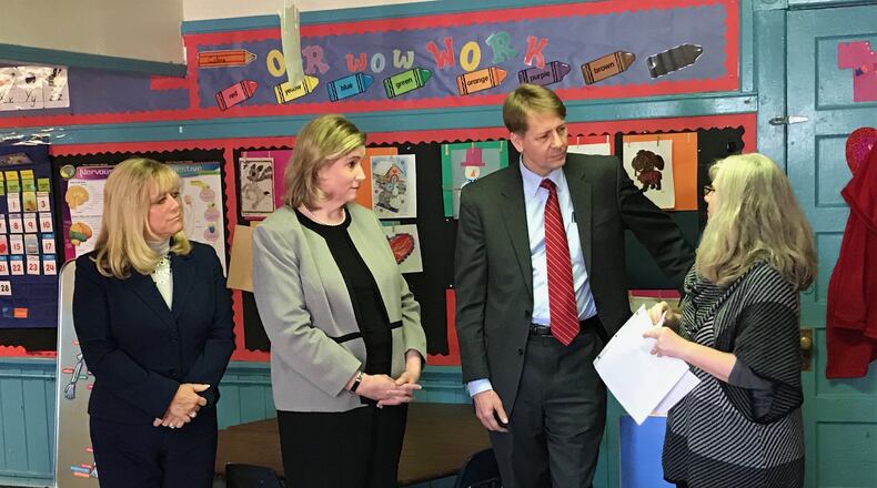 Democratic governor candidate Richard Cordray talks to Jama Hardern, owner/operator of Dayton’s Rainbow Years Child Care, about the process of becoming a five-star early childhood center in Ohio’s system. From left are Montgomery County Commissioner Debbie Lieberman and Dayton Mayor Nan Whaley. ERIC HIGGINBOTHAM / STAFF