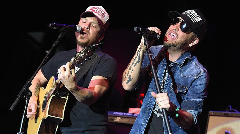 NASHVILLE, TN - SEPTEMBER 28:  Chris Lucas (L) and Preston Brust (R) of the LoCash Cowboys perform onstage at the Paradigm Agency at the Paradigm Party during Day 2 of the IEBA 2014 Conference on September 28, 2014 in Nashville, Tennessee.  (Photo by Rick Diamond/Getty Images for IEBA)