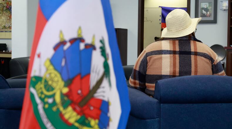 A woman from Haiti didn't want to be identified as she talks about her fears with Donald Trump winning the election. BILL LACKEY/STAFF