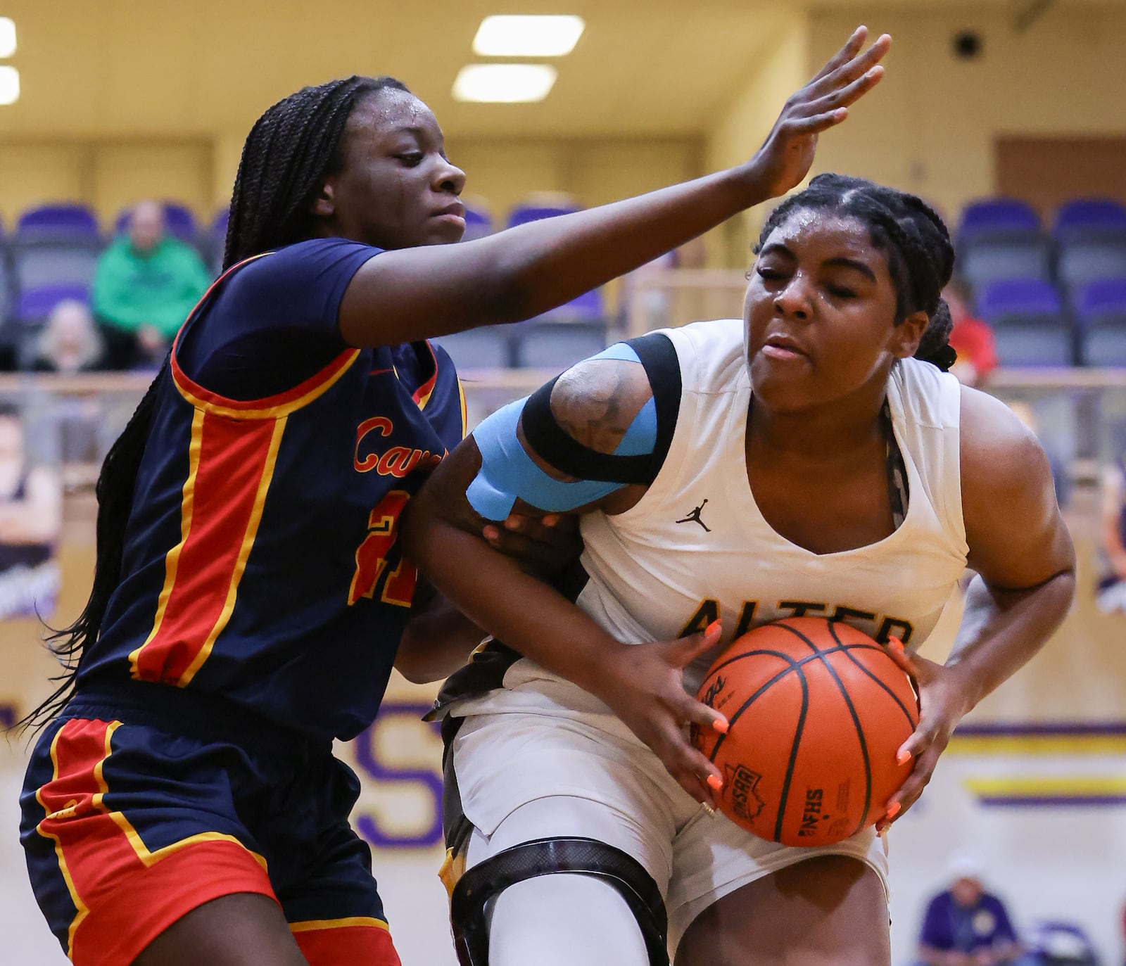 Alter senior forward Da'Shai Shepard shoots with pressure from Cincinnati Purcell Marian's Kourtney Peterson during a Division IV regional final on Saturday, March 7 at Vandalia-Butler's Student Activity Center. BRYANT BILLING / STAFF