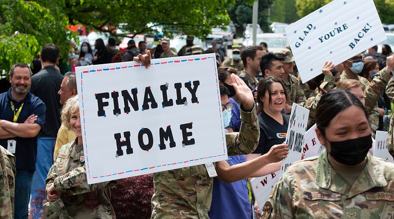 Airmen from the 88th Medical Group gather May 18 at Wright-Patterson Medical Center to welcome home friends and co-workers returning from a two-month deployment to Detroit. The returning Airmen helped administer more than 235,000 doses of the COVID-19 vaccine to Michigan residents. U.S. AIR FORCE PHOTO/R.J. ORIEZ