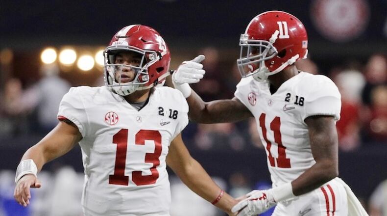 Alabama quarterback Tua Tagovailoa congratulates Henry Ruggs III (11) after his touchdown catch during the second half of the NCAA college football playoff championship game against Georgia, Monday, Jan. 8, 2018, in Atlanta. (AP Photo/David J. Phillip)