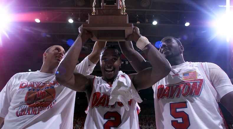 03/15/03  Dayton's Brooks Hall, D.J. Stelly, and Nate Green hold up the A-10 championship trophy after defeating Temple on Saturday afternoon.