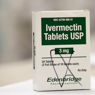 A box of ivermectin is shown in a pharmacy as pharmacists work in the background, Thursday, Sept. 9, 2021, in Ga. (AP Photo/Mike Stewart, File)