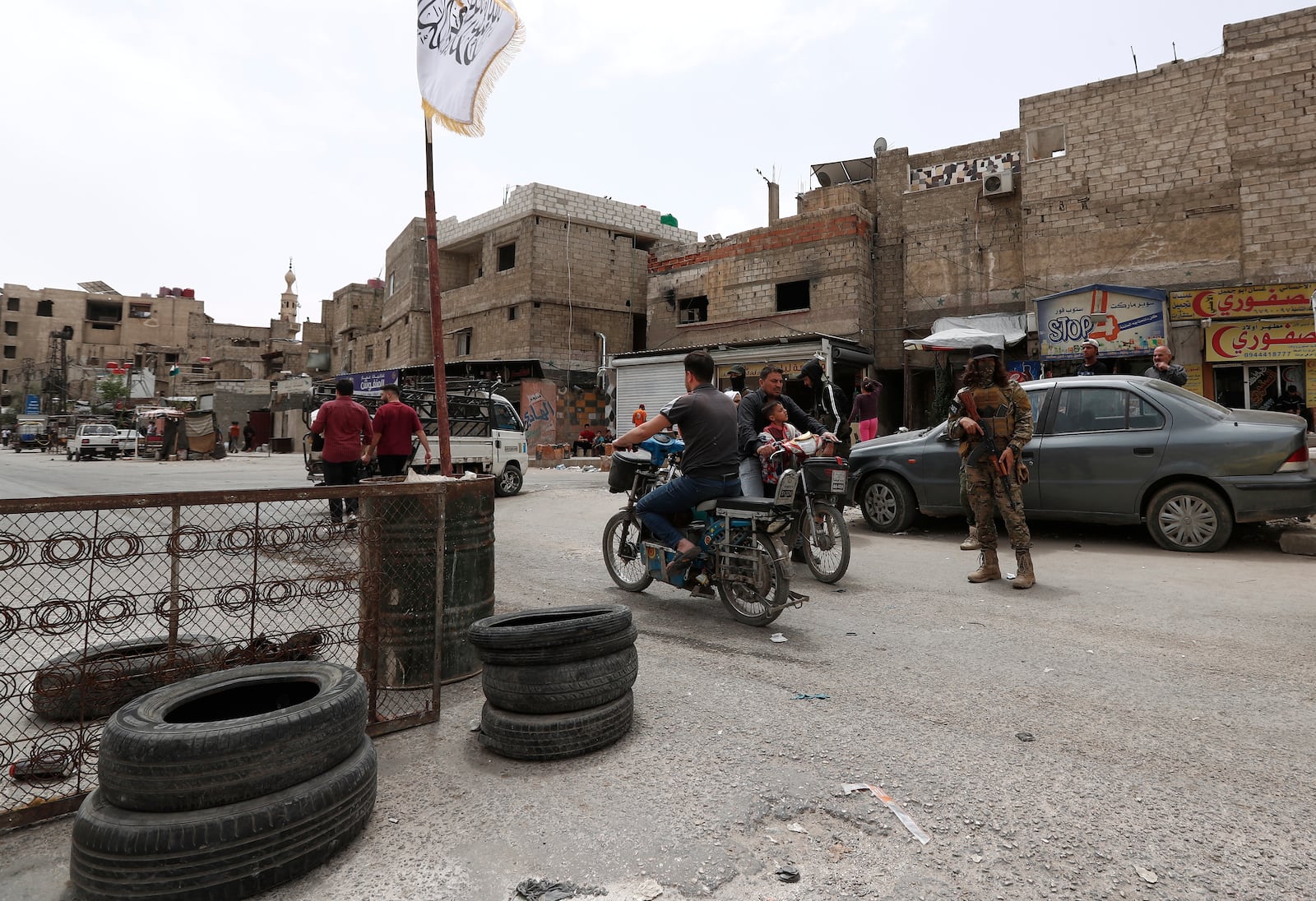 A Syrian government security forces gunman stand guards on a checkpoint at one of Jaramana suburb entrances, after clashes in the area between members of the minority Druze sect and pro-government fighters, in the southern suburb of Jaramana, Damascus, Syria, Wednesday, April 30, 2025. (AP Photo/Omar Sanadiki)