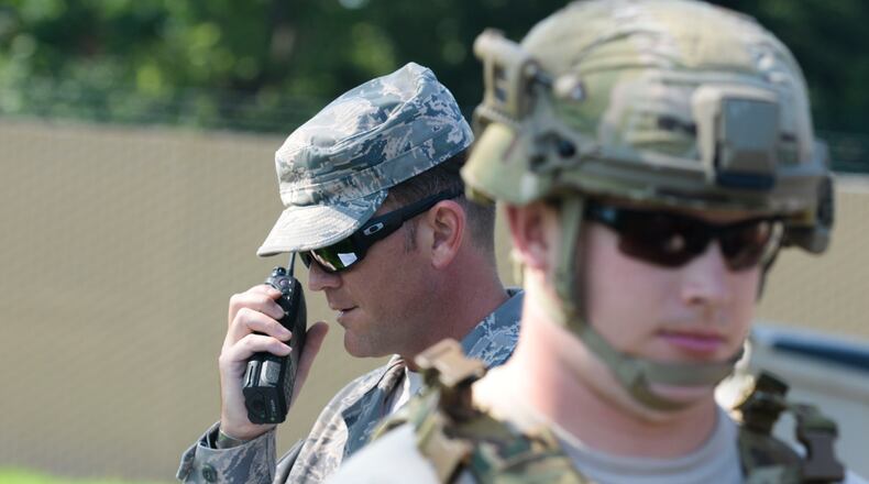 Staff Sgt. Michael Kent, 788th Civil Engineer Squadron, explosive ordinance disposal technician, radios back to the EOD control desk, the findings of Senior Airman Tyler Squibb, 788th CES, EOD technician, after he performed a recon on an unexploded ordinance during a inject of an exercise, at Wright-Patterson Air Force Base in August 2016. (U.S. Air Force photo / Wesley Farnsworth)