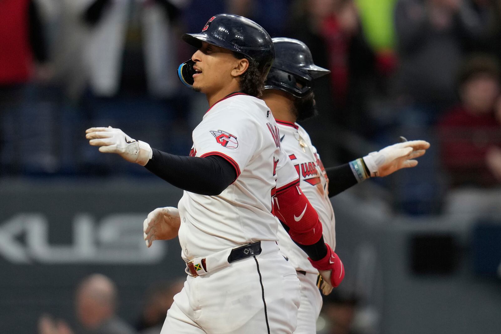 Cleveland Guardians' Bo Naylor, left, celebrates his home run with teammate Carlos Santana, right, in the seventh inning of a baseball game against the Minnesota Twins in Cleveland, Wednesday, April 30, 2025. (AP Photo/Sue Ogrocki)