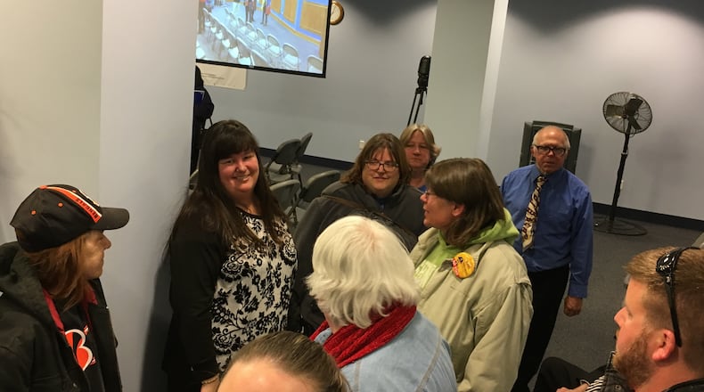 Ruskin school principal Jennifer Dearwester (second from left) talks with supporters at Dayton’s April school board meeting. JEREMY P. KELLEY / STAFF