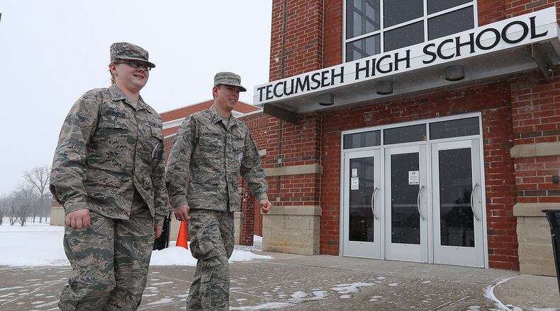 Tecumseh ROTC Cadet TSgt Harley Adamson and Cadet Major Matthew Lindamood walk past one of the entrances to Tecumseh High School this month. Tecumseh ROTC will try to reschedule a run planned to benefit Honor Flight and to honor veterans of the Bataan Death March. BILL LACKEY/STAFF