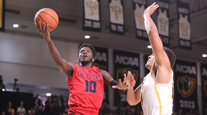 Dayton’s Jalen Crutcher shoots against Virginia Commonwealth’s Marcus Santos-Silva on Saturday, Feb. 10, 2018, at the Siegel Center in Richmond, Va. David Jablonski/Staff