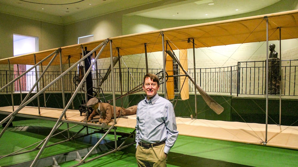 Alex Heckman, co-author of a new book about Carillon Historical Park, stands in front of the original 1905 Wright Flyer III, the world's first practical airplane and the only airplane ever designated a National Historic Landmark. DAYTON HISTORY/CONTRIBUTED