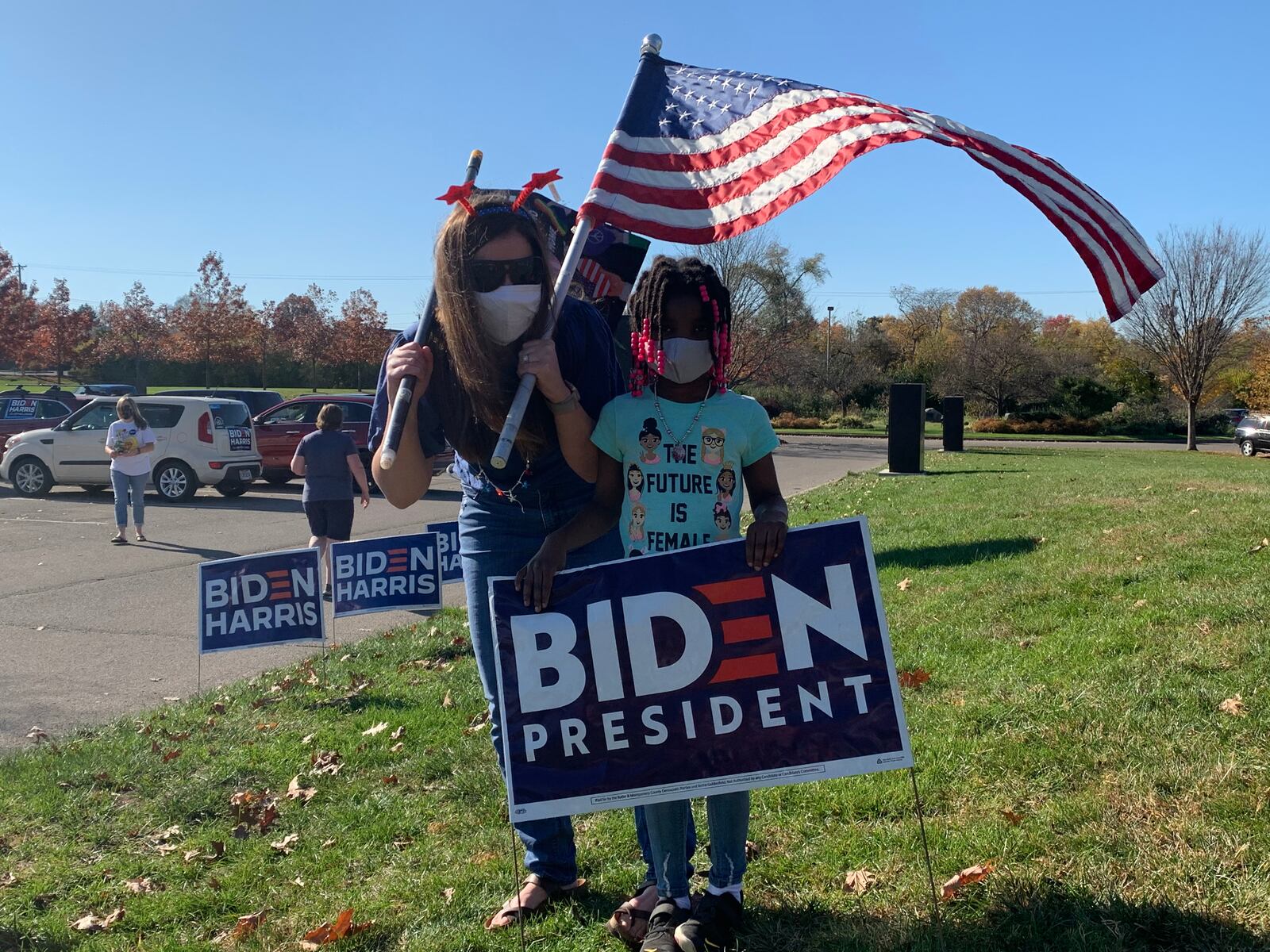 Jessica Bondurant and her daughter celebrate the apparent victory of President -Elect Joe Biden at a rally Sunday, Nov. 8, in Kettering. JOSH SWEIGART/STAFF
