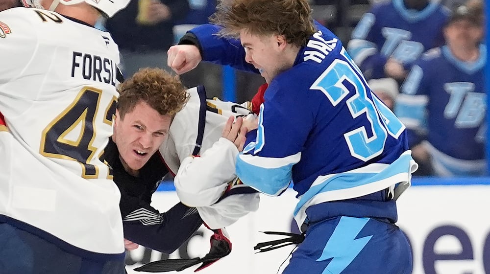 Tampa Bay Lightning left wing Brandon Hagel (38) fights Florida Panthers left wing Matthew Tkachuk during the third period of an NHL hockey game Thursday, Feb. 5, 2026, in Tampa, Fla. (AP Photo/Chris O'Meara)