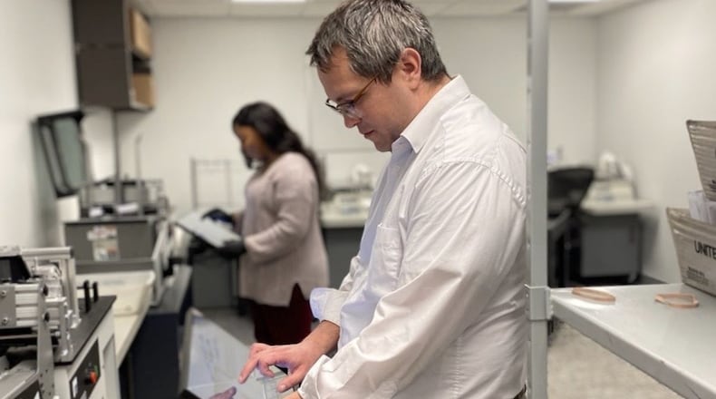 Montgomery County Board of Elections temporary employees Mike Miller and Imani Cunningham are scanning identification envelopes of voted ballots on the board’s new mail ballot verifiers. Staff are processing applications for absentee ballots and scanning the ballots that are received as Ohio has switched to mail-in voting after the state canceled in-person voting for the March 17 primary election due to the coronavirus crisis. The absentee ballots will be tabulated on April 28.