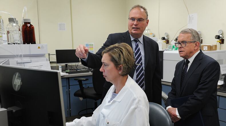 Montgomery County Coroner Dr. Kent Harshbarger, left, shows Ohio Governor Mike DeWine around the Miami Valley Regional Crime Lab, Monday May 9, 2022. The Governor visited the lab to discuss the new Ohio Crime Lab efficiency program that was developed to help eliminate-processing backlogs and increase the speed at which criminal evidence is analyzed in certified crime laboratories across the state. MARSHALL GORBY\STAFF
