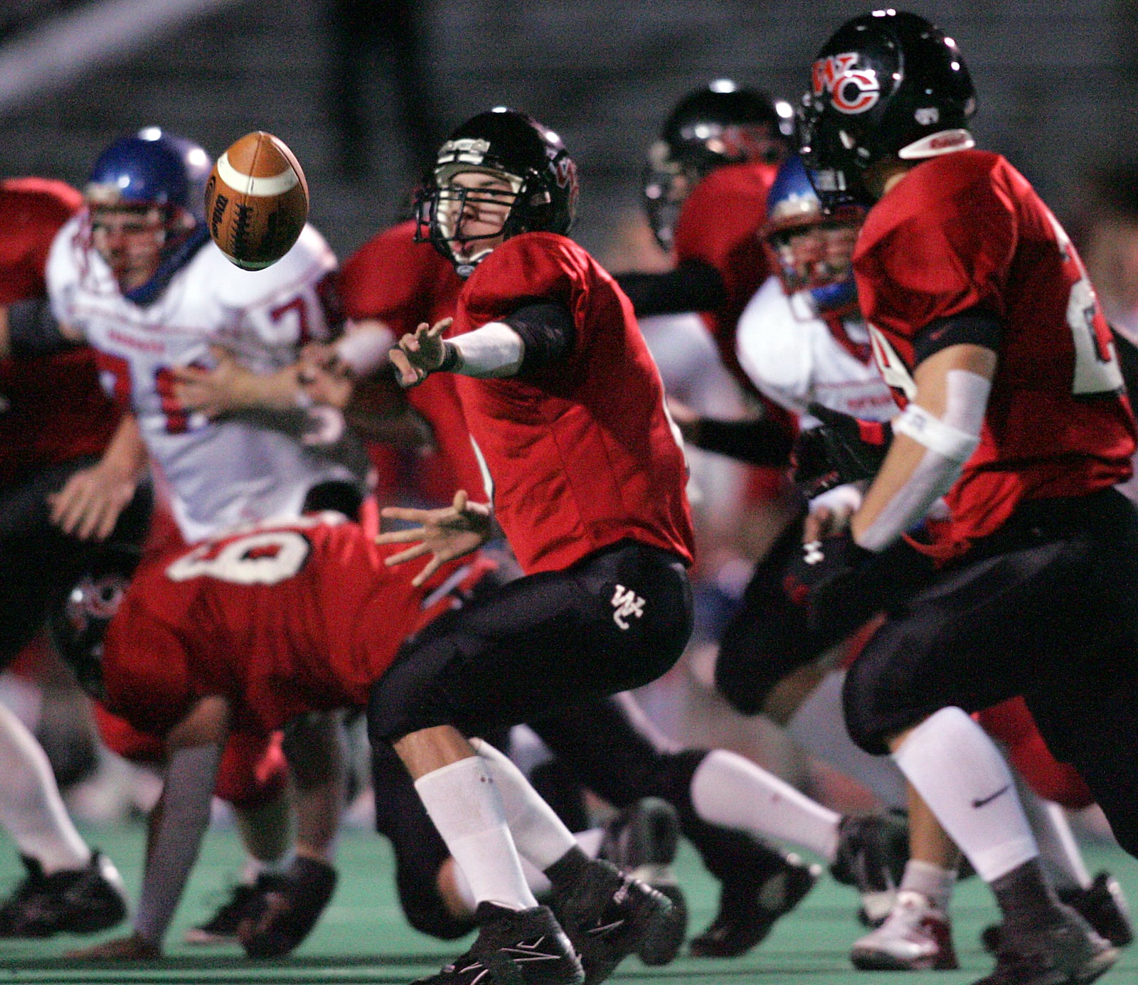 Scott Jackson, the West Carrollton quarterback, pitches the ball to Matt Evans on an option play. West Carrollton played Carroll High School in a Division II Region 8 semifinal game. In the first half Carroll jumped out to a 20 to 0 lead. The game was played at Welcome Stadium. RON ALVEY / STAFF PHOTO