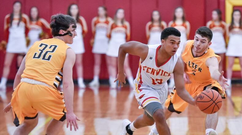 Fenwick’s Jordan Rucker dribbles the ball between Alter’s Dominic Ruffolo (right) and Brady Uhl during Friday night’s game in Middletown. Alter won 56-38. NICK GRAHAM/STAFF