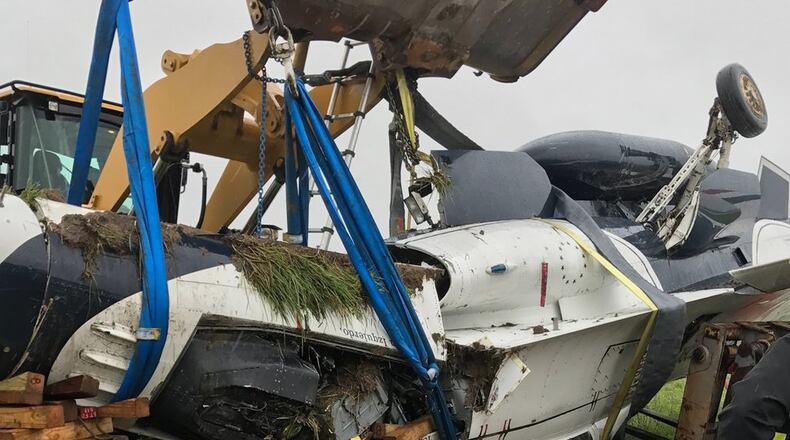 Crews remove wreckage of a Thunderbird jet that flipped over after taxiing at Dayton International Airport on Friday, June 23, 2017. A Thunderbirds statement said the F-16D Fighting Falcon was conducting a “single-ship familiarization” when it had the “mishap.” CONTRIBUTED