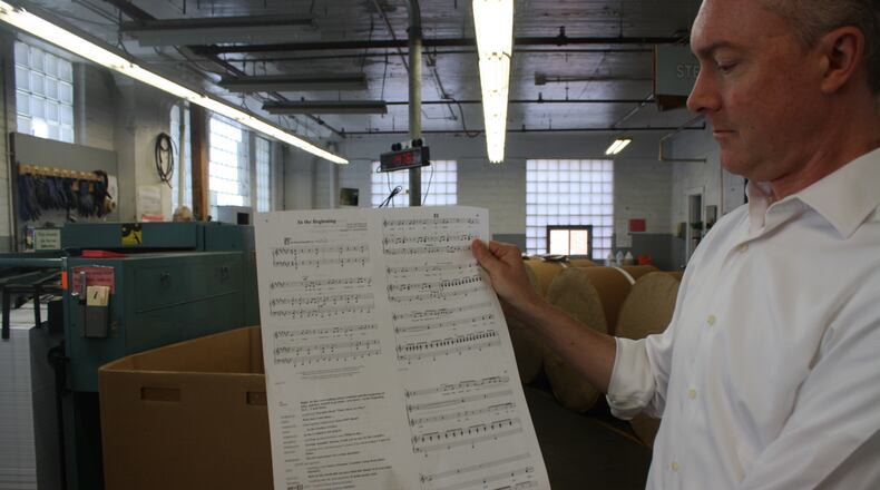 Reiff Lorenz, Lorenz Corp. chief executive, with sheet music produced by his company. The Lorenz Corp. is a fifth-generation family business that publishes sheet music in downtown Dayton at 501 E. Third St. KAITLIN SCHROEDER/STAFF