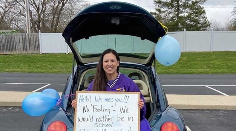 A Bell Creek Intermediate teacher holds a special message for her students on Wed., April 1. CONTRIBUTED