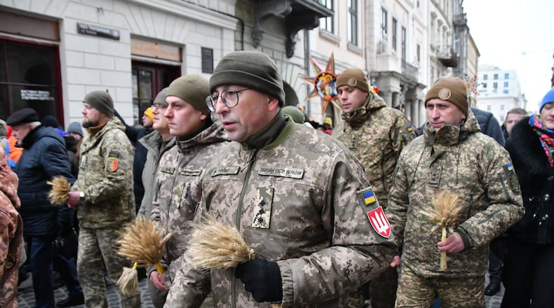 Ukrainian servicemen attend a parade on Orthodox Christmas eve in downtown Lviv, Ukraine, on Wednesday, Dec. 24, 2025. (AP Photo/Mykola Tys)