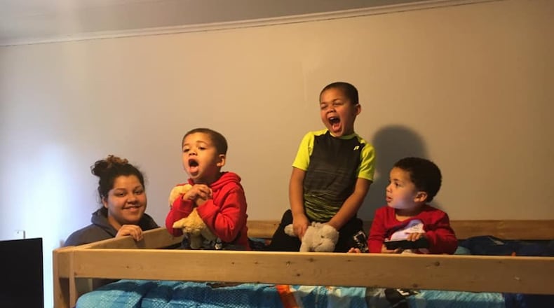 Kayla Richardson, 29, of Middletown, called receiving two beds from Sleep in Heavenly Peace ‘a blessing.’ Her three sons, from left, Jayden, Trevion and Amarion received beds Saturday. SUBMITTED