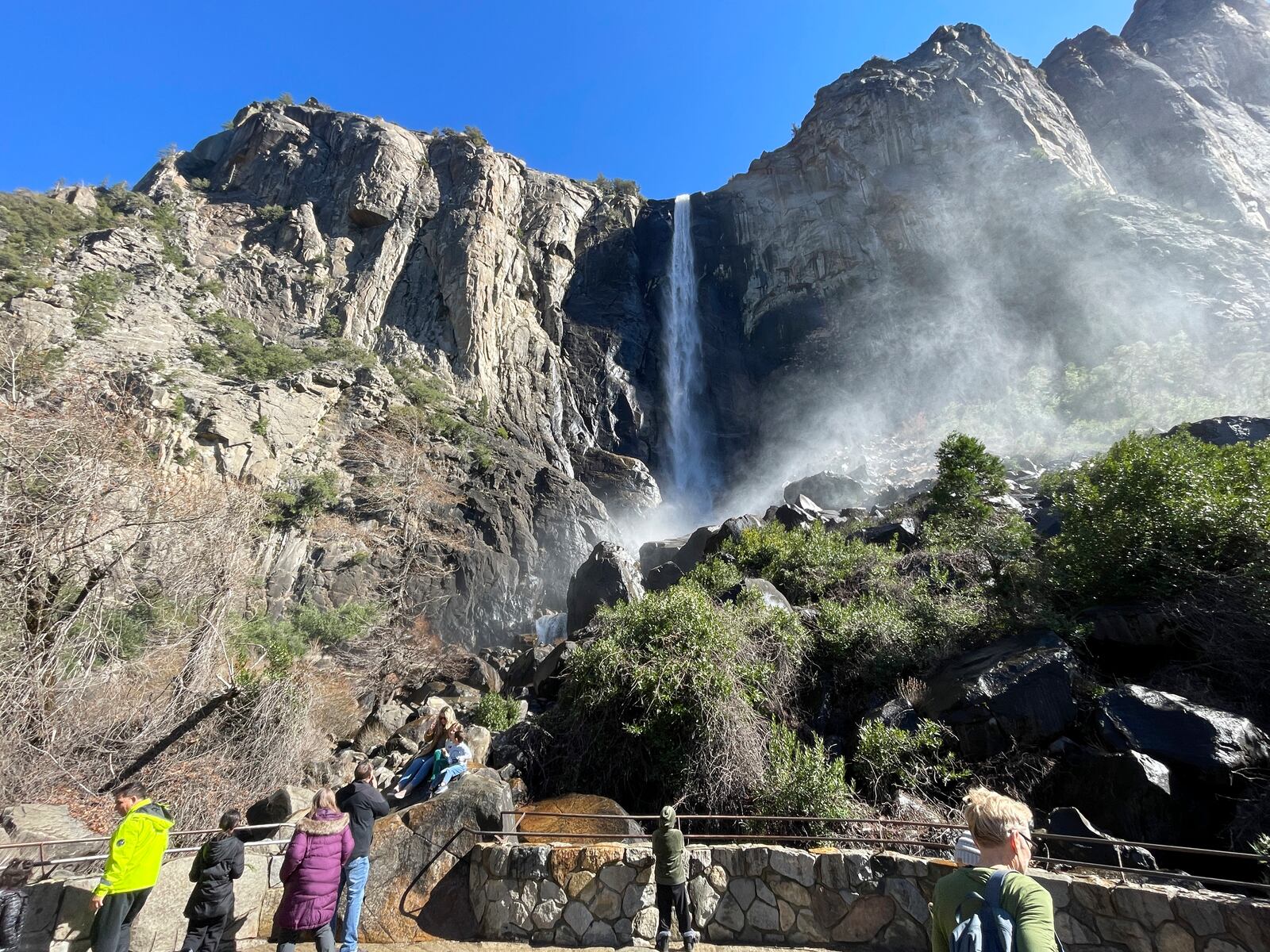 FILE - Visitors take in a view of Bridalveil Fall, Feb. 20, 2025, in Yosemite National Park, Calif. (AP Photo/Haven Daley, File)