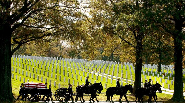 FILE - A U.S. Army Caisson team carries the remains of Army Pfc. Tramaine J. Billingsley during burial services at Arlington National Cemetery in Arlington, Va., Nov. 2, 2010. The return of horse-drawn caissons at Arlington National Cemetery is being delayed for at least months or a year, the Army said Friday, April 12, 2024, as officials struggle to improve the care of the horses, after two died in 2022 as a result of poor feed and abysmal living conditions. (AP Photo/Kevin Wolf, File)