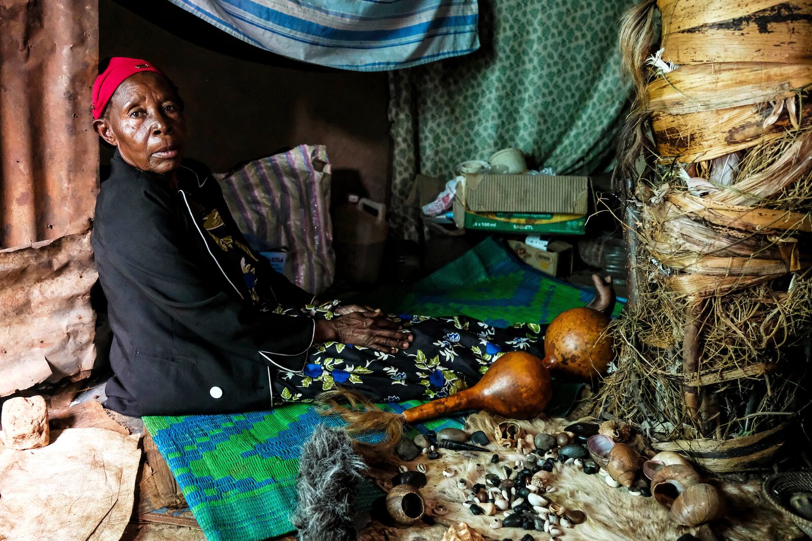 Traditional healer Rose Mukite poses for a photograph inside her igloo-shaped shrine during an interview with The Associated Press in Kampala, Uganda Monday, June 23, 2025. (AP Photo/Hajarah Nalwadda)